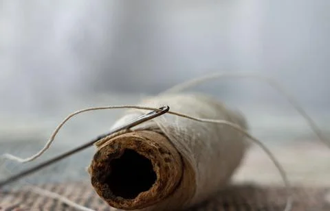 Very old thread and sewing needle Stock Photos