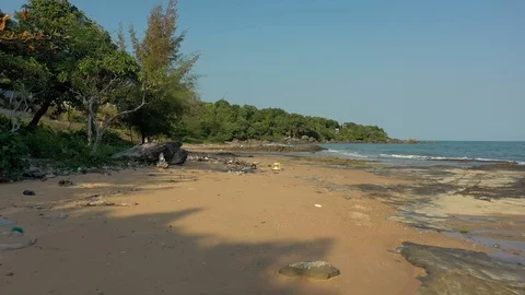 Very polluted beach shore in Phu Quoc island Vietnam Asia with girl picking up g Stock Footage 124327490