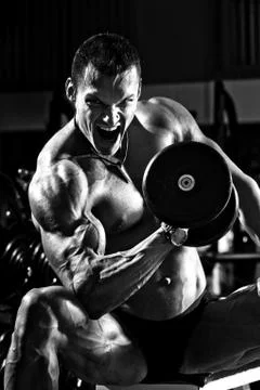 Very power athletic guy , execute exercise with dumbbells Foto stock