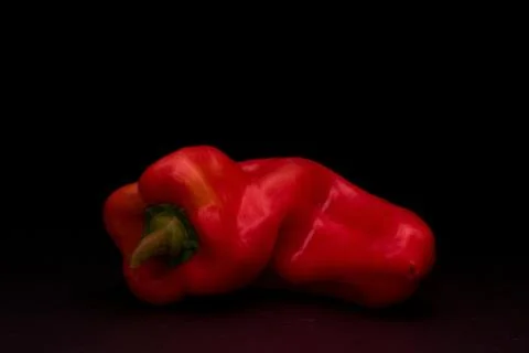 A very red pepper on black background Stock Photos