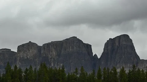 A very rugged ridge of mountains has a gray sky and clouds Stock Footage 142283393