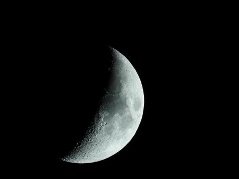 A very sharp close-up of the rising crescent moon in the night sky Stock Photos