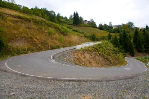 A very sharp turn in the mountain road. Stock Photos