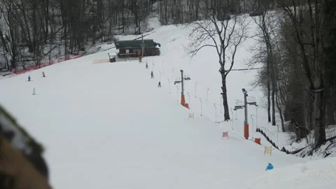 Very Simple Ski Hill in the Forest with a Working Lift. Few People. Stock Footage 297493423