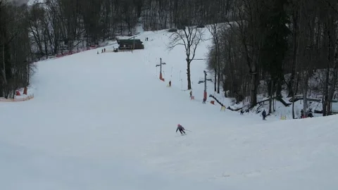 Very Simple Ski Hill in the Forest by the River with a Working Lift. Few People. Video stock 297493432