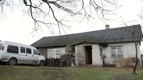 Very Simple White Brick House With A Van And Scraps In Front Of It Stock Footage 260471948