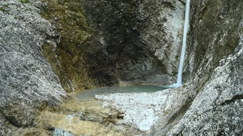A very slim waterfall is falling into a small natural pool Stock-Footage 211508283