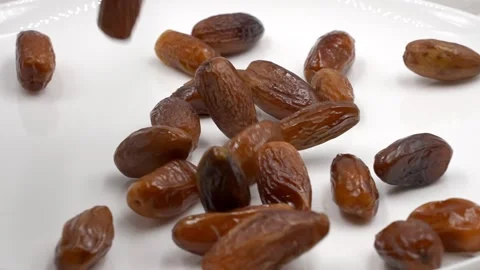 Very slowly falling dates rotating Stock Footage 154047040