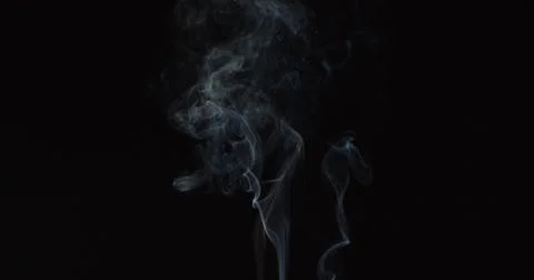 Very sparse smoke trail over dark background Stock Photos