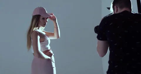 Very textured blonde model poses for the camera of the photographer in the Stock Footage 99509378