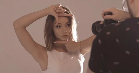 Very textured blonde model poses for the camera of the photographer in the Stock Footage 99509385