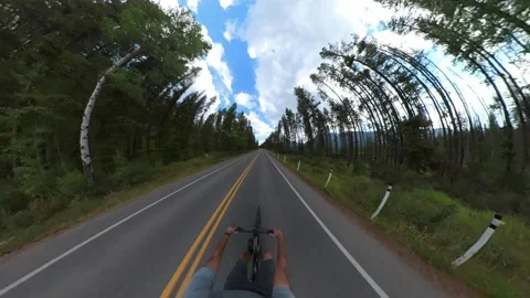 A very wide-angle view from an action camera recording a cyclist riding Banff Stock Footage 285889342