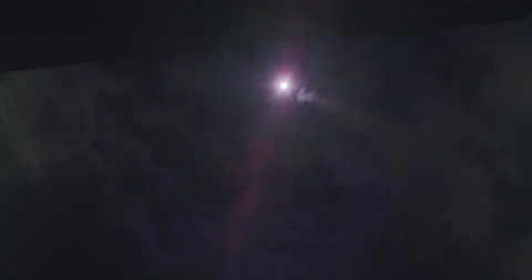 Very wide shot of a partial solar eclipse. Clouds moving in front of the Stock Footage 155486310
