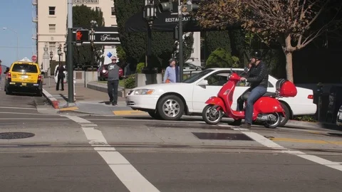 Vespa takes off from red light in san francisco Stock Footage 83526748