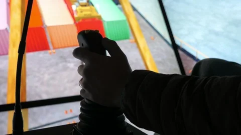 Vessel crane simulator with a sailor controlling the load movement in cockpit Stock Footage 119951022