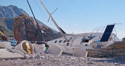 Vessel crashes into shore due to wind and remains lying down Stock Footage 266196827