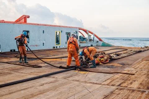 Vessel crew preparing vessel for static tow tanker lifting Stock Photos