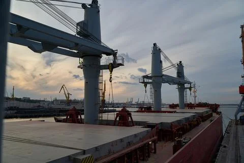 Vessel dry cargo on loading, unloading in port. Bulker in port. Stock Photos