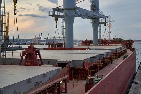 Vessel dry cargo on loading, unloading in port. Bulker in port. Stock Photos