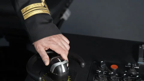 Vessel. Navigation bridge. Hand moves thruster. Officer steers vessel. Stock Footage 240842712