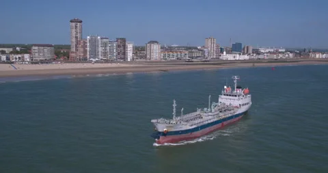 Vessel transporting gas next to a small beach Video stock 197557764