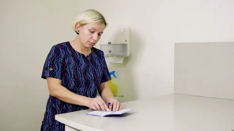 The vet making a note of the vaccination in a veterinary passport of animal. 4K Stock Footage 85591713