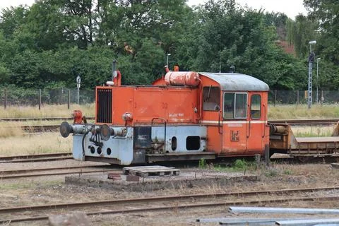 Veteran orange pull train on old railway track Stock Photos