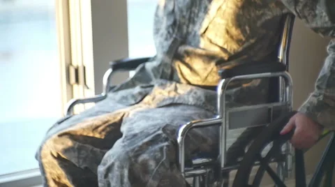 Veteran soldier moving wheelchair on sidewalk 3 Stock Footage