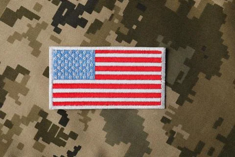 Veterans day. USA army patch on camouflage fabric, top view Stock Photos