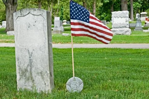 Veteran's grave with flag Stock Photos