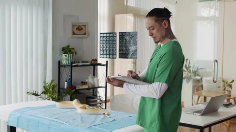 Veterinarian Filling Form Examining Python Health at Clinic Stock Footage 304540059