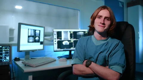 A veterinarian typing something on his computer and then turns around at the Stock Footage 237550029