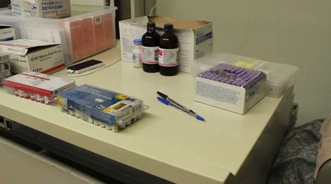 Veterinary supplies including vaccines on a table, panning shot. Stock Footage 35577313