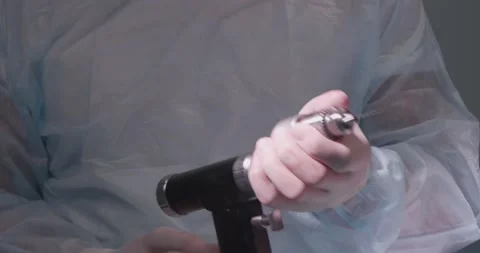 A veterinary surgeon in the operating room inserts a drill into a medical drill Stock Footage 238862638