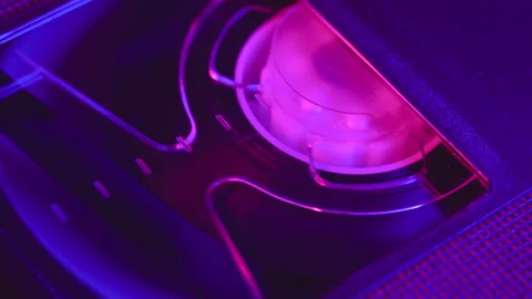 VHS cassette insert in VCR, play, stop, eject, close up, blue and purple light Stock Footage 155714388