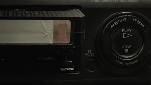 Vhs cassette inserted into vintage vcr player Stock Footage 324461793