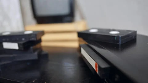 VHS cassette pops out of the player. Male hand takes a cassette from the device. Stock Footage 319890422