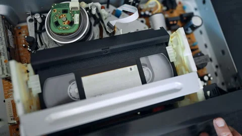 VHS cassette recorder inside the player. 動画素材 319890508