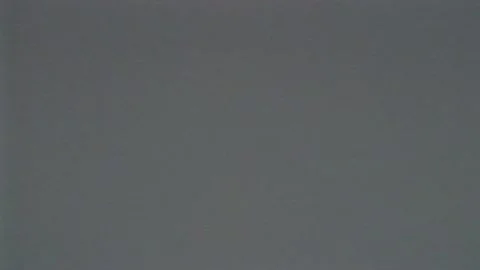 VHS flickering, defects, noise and artifacts on gray TV screen. Effect Stock Footage 168367930