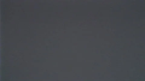 VHS flickering, defects, noise and artifacts on gray TV screen. Screensaver of Stock Footage 194292981