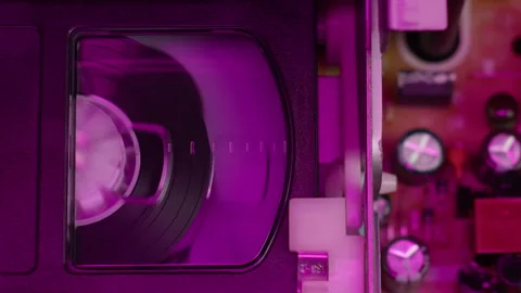 VHS PLAYER, Old video recorder inside in neon pink light close-up, VHS. Retro Stock Footage 259077873
