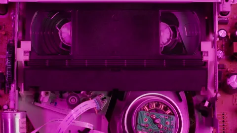 VHS PLAYER, Old video recorder inside in neon pink light close-up, VHS. Retro Stock Footage 262578632