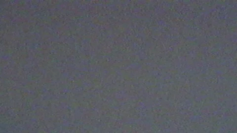 VHS shaking, flickering, defects, noise and artifacts on gray TV screen. Gray Stock Footage 159293416