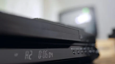 VHS tape appears from the recorder. Close up. Hand takes away the tape Stock Footage 320426661