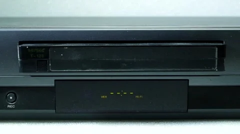 VHS tape being inserted into a VCR machine 스톡 동영상 46892275