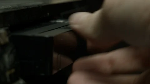 VHS tape being placed into dusty tape deck Stock Footage