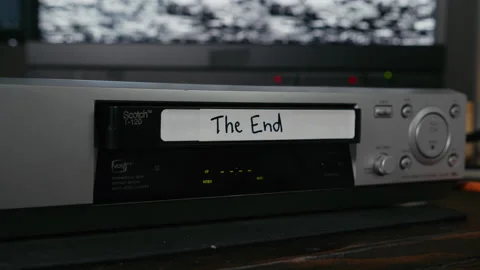 VHS Tape Ejected from a VCR. Female Hand. Labeled "The End" Stock Footage 137441067