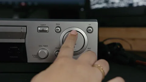 VHS Tape Inserted and Ejected from a VCR. Female Hand. CU on Play Stock Footage 137437721