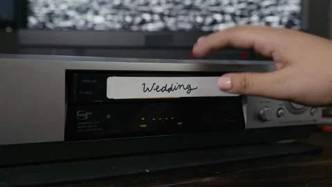 VHS Tape Inserted and Ejected from a VCR. Female Hand. "Wedding" in cursive. Stock Footage 137439025