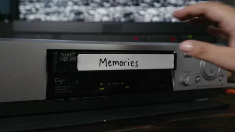 VHS Tape Inserted and Ejected from a VCR. Female Hand. Labeled "Memories" Stock Footage 137442348